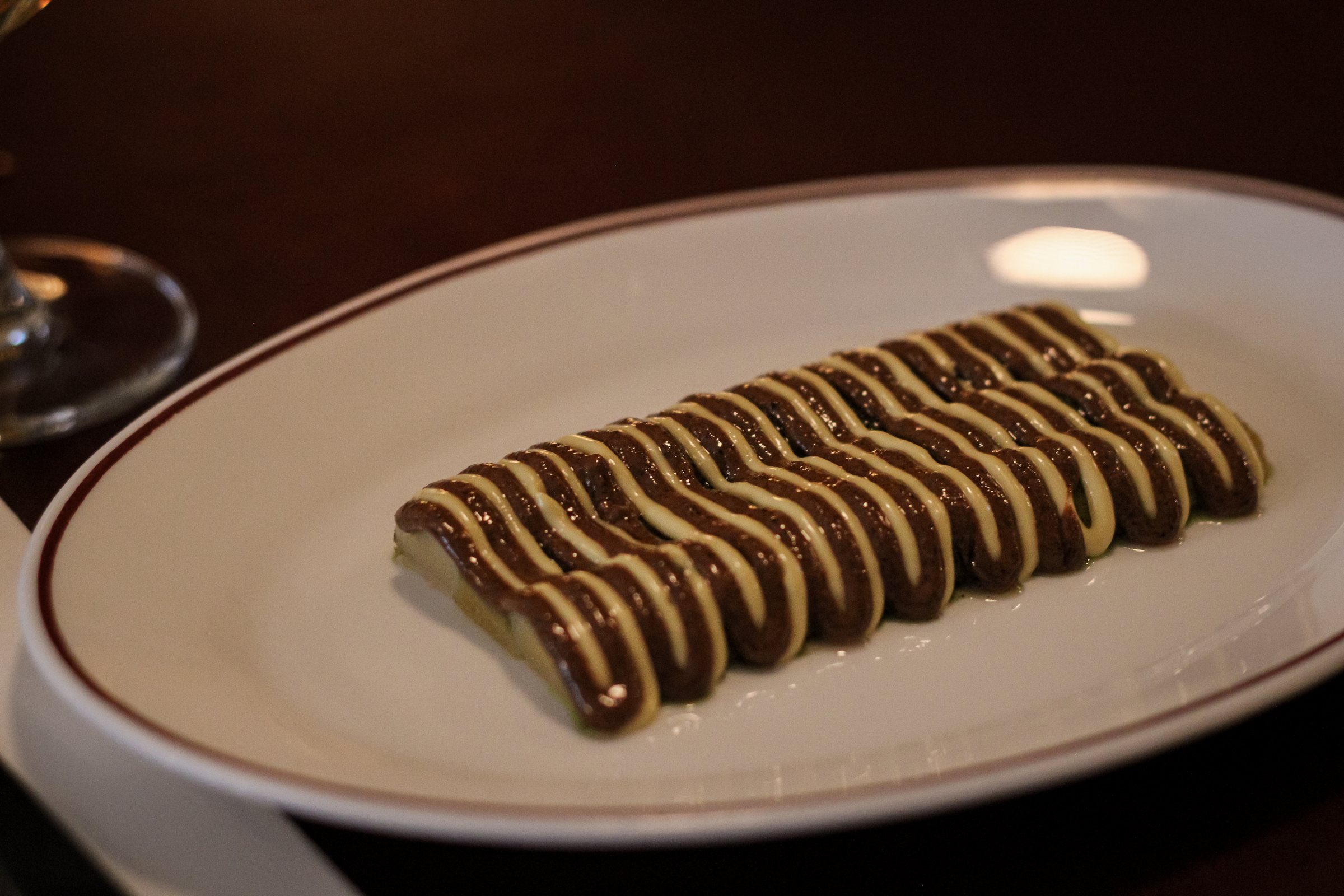 Chocolate mousse piped in a striped wave pattern with white chocolate